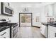 Kitchen with stainless steel appliances, and sliding glass door to the backyard at 566 Searchlight Dr, Las Vegas, NV 89110