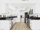 Modern kitchen features white cabinets, stainless steel appliances, and black marble countertops at 566 Searchlight Dr, Las Vegas, NV 89110