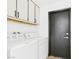 Laundry room with full-size appliances and extra storage above at 566 Searchlight Dr, Las Vegas, NV 89110