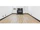 Bright living room featuring light wood flooring and a modern fireplace at 566 Searchlight Dr, Las Vegas, NV 89110