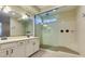 A luxurious bathroom featuring double sinks and a modern walk-in shower at 5697 Garriga Dr, Las Vegas, NV 89135