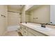 Well-lit bathroom with a double sink vanity and a shower-tub combo at 5697 Garriga Dr, Las Vegas, NV 89135