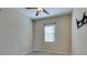 Bedroom with a ceiling fan, window, and a modern wall-mounted TV bracket at 5697 Garriga Dr, Las Vegas, NV 89135