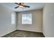 Bright bedroom featuring plush carpet, neutral walls, ceiling fan, and natural light from two windows at 5697 Garriga Dr, Las Vegas, NV 89135