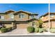 Attractive two-story home with a paved driveway, two-car garage and manicured front yard landscaping at 5697 Garriga Dr, Las Vegas, NV 89135