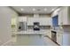 Modern kitchen with stainless steel appliances, granite countertops, and a breakfast bar with pendant lighting at 5697 Garriga Dr, Las Vegas, NV 89135