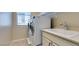 Laundry room featuring a stacked washer and dryer, sink, and storage at 5697 Garriga Dr, Las Vegas, NV 89135