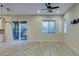 Bright living room featuring wood-look tile floors, recessed lighting, and sliding glass door to patio at 5697 Garriga Dr, Las Vegas, NV 89135
