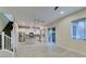 Open concept living area with a modern kitchen, staircase, and wood-look tile flooring at 5697 Garriga Dr, Las Vegas, NV 89135