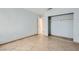 Bedroom featuring tile flooring, a closet, and neutral paint at 5913 Smoke Ranch Rd # A, Las Vegas, NV 89108