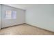 Cozy bedroom featuring tile flooring, a bright window, and neutral walls at 5913 Smoke Ranch Rd # A, Las Vegas, NV 89108
