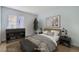 Staged bedroom featuring a wooden bed frame, sleek decor, and natural light at 5913 Smoke Ranch Rd # A, Las Vegas, NV 89108