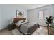 Staged bedroom with a plush bed, decorative lamps, and natural light creating a cozy retreat at 5913 Smoke Ranch Rd # A, Las Vegas, NV 89108