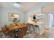 Modern dining area with a wooden table, seating for eight, and a pass-through to the kitchen at 5913 Smoke Ranch Rd # A, Las Vegas, NV 89108