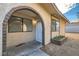 Home exterior showcasing an arched brick entrance, tidy landscaping, and a secure front door at 5913 Smoke Ranch Rd # A, Las Vegas, NV 89108