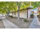 Side view of a tan home with brown trim and trees next to a sidewalk at 5913 Smoke Ranch Rd # A, Las Vegas, NV 89108