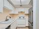 This bright kitchen offers all-white appliances and cabinetry, and a tile floor at 5913 Smoke Ranch Rd # A, Las Vegas, NV 89108