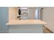 A bright kitchenette offers a bar top, while including a stacked washer and dryer at 5913 Smoke Ranch Rd # A, Las Vegas, NV 89108