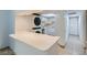 A convenient kitchenette includes stacked washer and dryer with bar top at 5913 Smoke Ranch Rd # A, Las Vegas, NV 89108