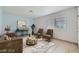 Staged living room with comfortable seating, stylish decor, and plenty of natural light from the window at 5913 Smoke Ranch Rd # A, Las Vegas, NV 89108