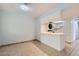 Open living space with breakfast bar, tile flooring, laundry, and access to the adjacent kitchen at 5913 Smoke Ranch Rd # A, Las Vegas, NV 89108