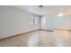 The open living area features tile flooring, a window, and a front door at 5913 Smoke Ranch Rd # A, Las Vegas, NV 89108