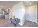 Open entryway with white trim, wood-look floors, and a comfy bench at 6172 Violet Fls # 42, North Las Vegas, NV 89081