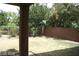 View of backyard that features a well-manicured lawn, with trees and a brick perimeter wall at 6528 Chebec St, North Las Vegas, NV 89084