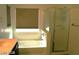 Bathroom featuring a vanity with black cabinets, bathtub, and a window at 6528 Chebec St, North Las Vegas, NV 89084
