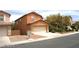 Two-story home featuring an attached two-car garage and low maintenance landscaping at 6528 Chebec St, North Las Vegas, NV 89084