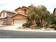 Attractive home with a two-car garage and a well-manicured front yard with green shrubs at 6528 Chebec St, North Las Vegas, NV 89084