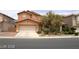 Charming two-story home with a well-maintained front yard and an attached two-car garage at 6528 Chebec St, North Las Vegas, NV 89084