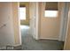 Hallway with carpet, a window, and doors leading to other rooms at 6528 Chebec St, North Las Vegas, NV 89084