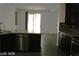 Modern kitchen featuring stainless steel dishwasher, granite counter tops and exterior view at 6528 Chebec St, North Las Vegas, NV 89084