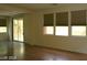 Spacious living room with hardwood floors, sliding glass doors, and three windows at 6528 Chebec St, North Las Vegas, NV 89084