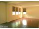 Bright living room with laminate flooring, multiple windows, and lots of space for entertaining at 6528 Chebec St, North Las Vegas, NV 89084