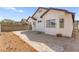 Backyard view showcases a white house, with a large patio and a block wall creating a private outdoor space at 7008 Brown Derby Circle Dr, Las Vegas, NV 89128