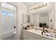This bathroom features a large mirror, white tiling, and shower at 7008 Brown Derby Circle Dr, Las Vegas, NV 89128