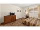 This bedroom is illuminated with natural light and features a dresser and patterned bedspread at 7008 Brown Derby Circle Dr, Las Vegas, NV 89128