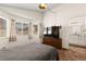 This bedroom features a large window, dresser, and gray bedspread at 7008 Brown Derby Circle Dr, Las Vegas, NV 89128