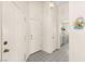 The hallway leads to a laundry room and features white walls and tile flooring at 7008 Brown Derby Circle Dr, Las Vegas, NV 89128
