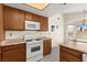 Well-lit kitchen with gas range, microwave, and ample counter space for meal preparation at 7008 Brown Derby Circle Dr, Las Vegas, NV 89128