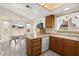 Functional kitchen with white appliances, warm wood cabinets, and an adjacent dining area at 7008 Brown Derby Circle Dr, Las Vegas, NV 89128