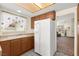 Kitchen area with white refrigerator, tiled floor, and adjacent living space at 7008 Brown Derby Circle Dr, Las Vegas, NV 89128
