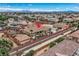 Scenic aerial view of a home surrounded by mature palms and a detached garage, enclosed with brick wall at 7521 Prancing Pony Ct, Las Vegas, NV 89131
