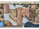 Aerial view showcases the layout of a desert property including driveway, pool, and buildings at 7521 Prancing Pony Ct, Las Vegas, NV 89131