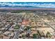 Expansive aerial view of a desert community showcasing a beautiful home with mountain views and ample space at 7521 Prancing Pony Ct, Las Vegas, NV 89131