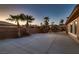 Large concrete patio with lush palm trees, perfect for outdoor entertaining at 7521 Prancing Pony Ct, Las Vegas, NV 89131