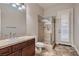 Bathroom with granite counters, tile floors, and a stand up shower with glass surround at 7521 Prancing Pony Ct, Las Vegas, NV 89131