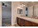 Bathroom vanity with dual sinks, dark wood cabinetry, and a large mirror for a luxurious feel at 7521 Prancing Pony Ct, Las Vegas, NV 89131